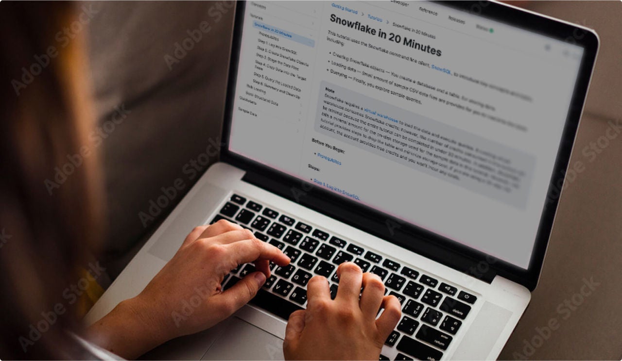 Someone looking at Snowflake documentation on a computer