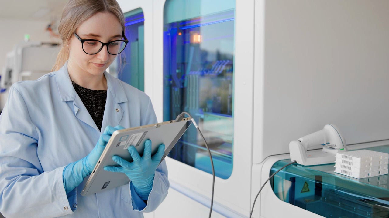 lady in pharma industry holding a device