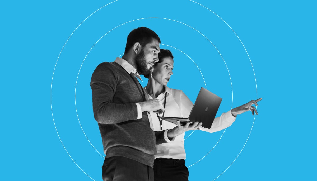 Two coworkers looking at a computer togehter