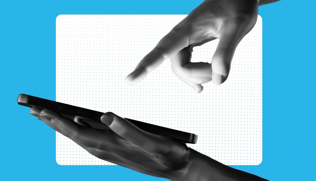 hand holding ipad and other hand pointing at ipad; blue and white dotted background