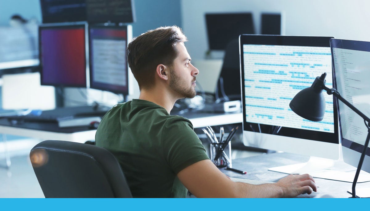 Data scientist working on code in an office