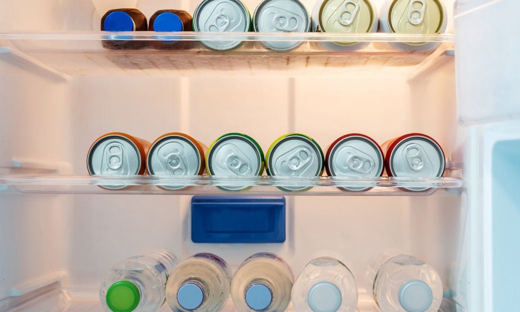 canned drinks laying down in a refrigerator