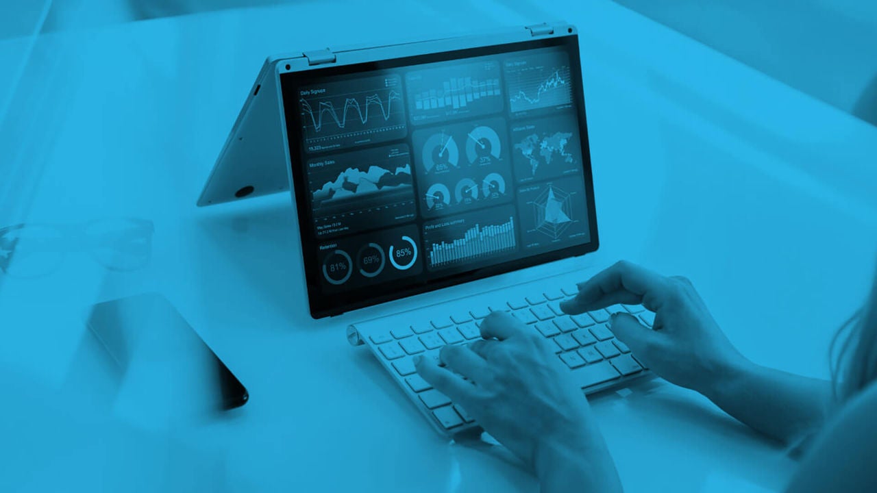 Professional typing on computer looking at data analytics