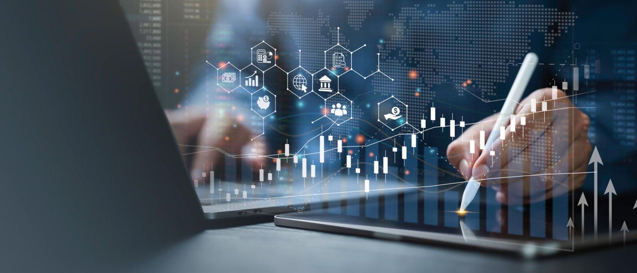 Digital illustration of a person using a laptop and writing on a tablet with charts and financial icons overlaid on the image.