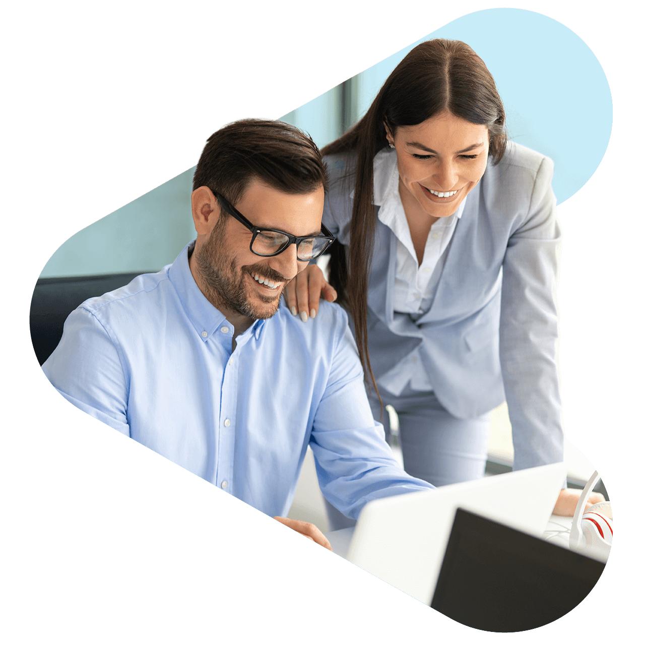 Two coworkers looking at a computer together
