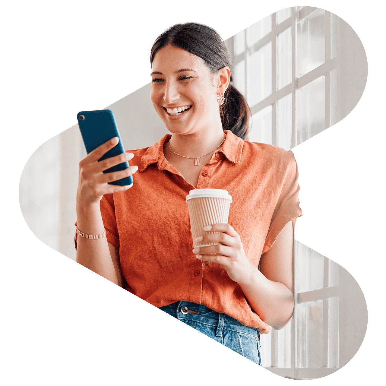 woman holding coffee and phone
