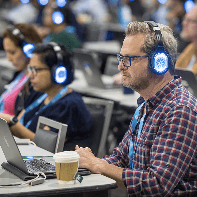 people wearing headphones during a live demo