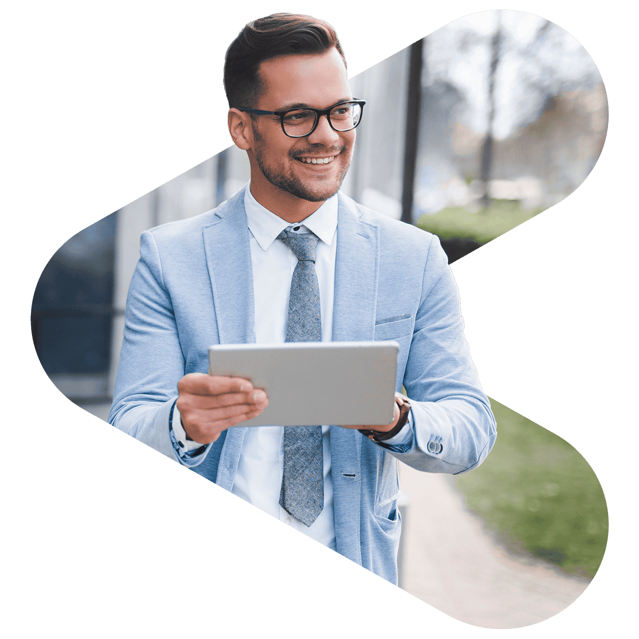 man wearing glasses and blue suit looking and smiling to his left while holding a tablet